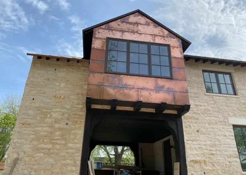 Copper metal panel facade on a stone building for Skylight Installation in Grandview