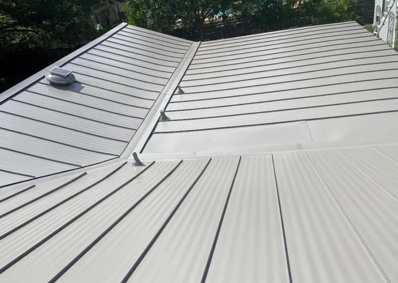 Solar attic fan installed on a metal roof for Roof Ventilation in Grandview