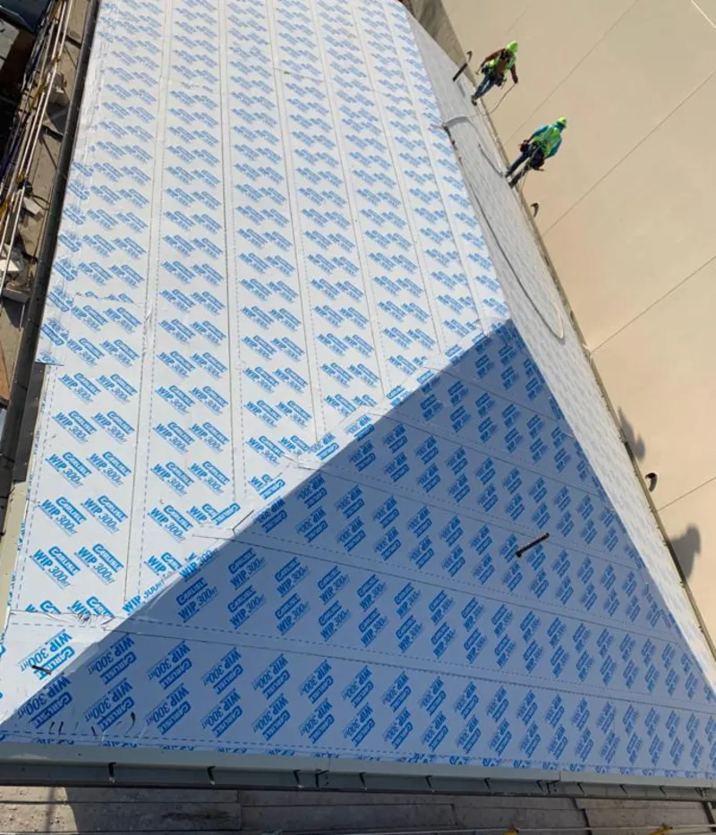 Professional roofers installing underlayment on a metal roof in Grandview